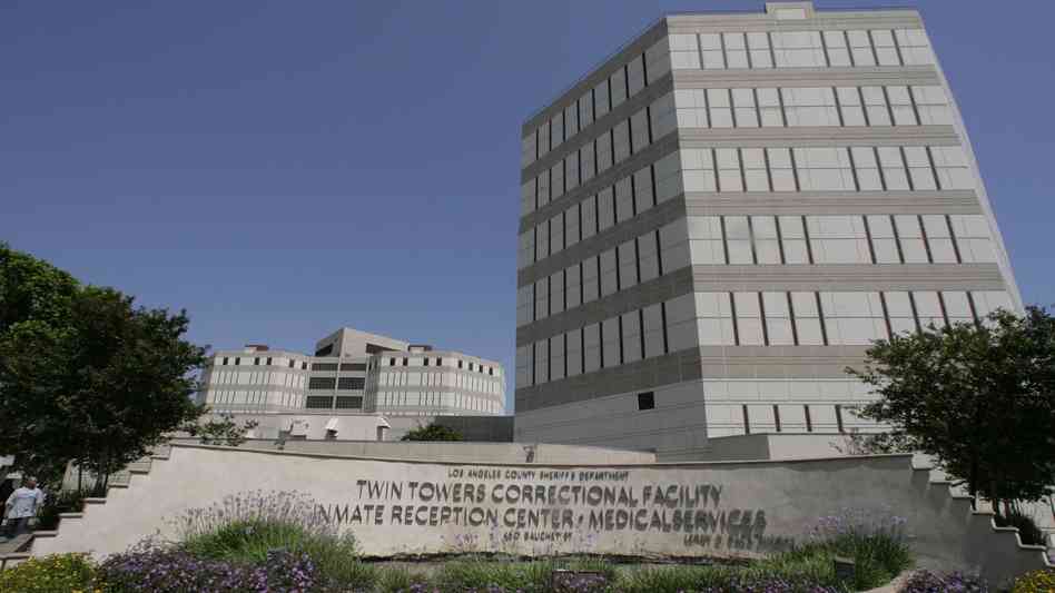 A modern correctional facility with a sign reading